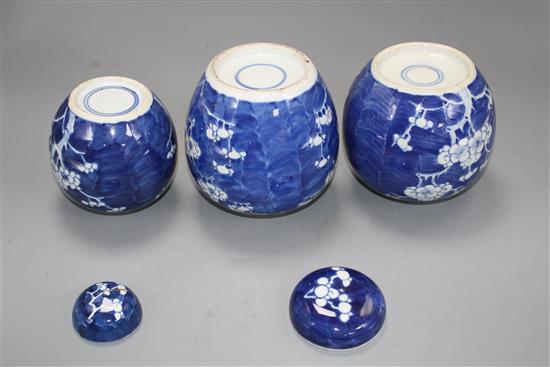 Three Chinese blue and white prunus jars and two covers, early 20th century, height 12cm - 13.5cm